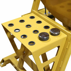 Yellow metal machine with circular holes and metallic buttons on a white background