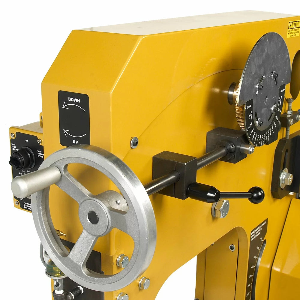 Yellow metal lathe machine with control knobs on a white background