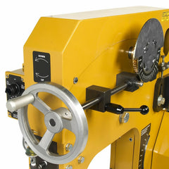 Yellow metal lathe machine with control knobs on a white background