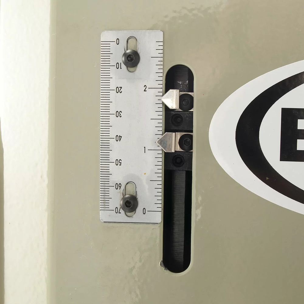 Metal ruler attached to a wall with a logo in the corner