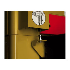 Close-up of a yellow machine with a red background