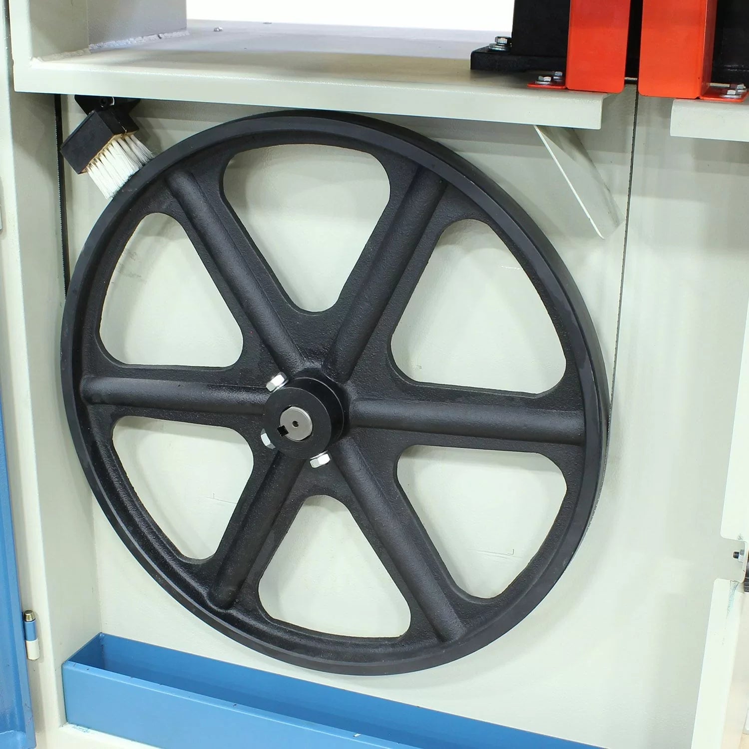Black wheel on a machine in a workshop setting