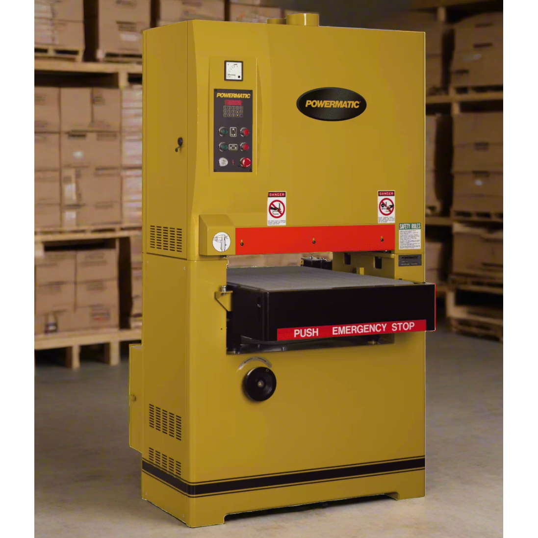 Yellow industrial machine with Powermatic branding in a warehouse setting