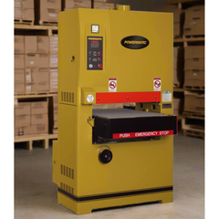 Yellow industrial machine with Powermatic branding in a warehouse setting